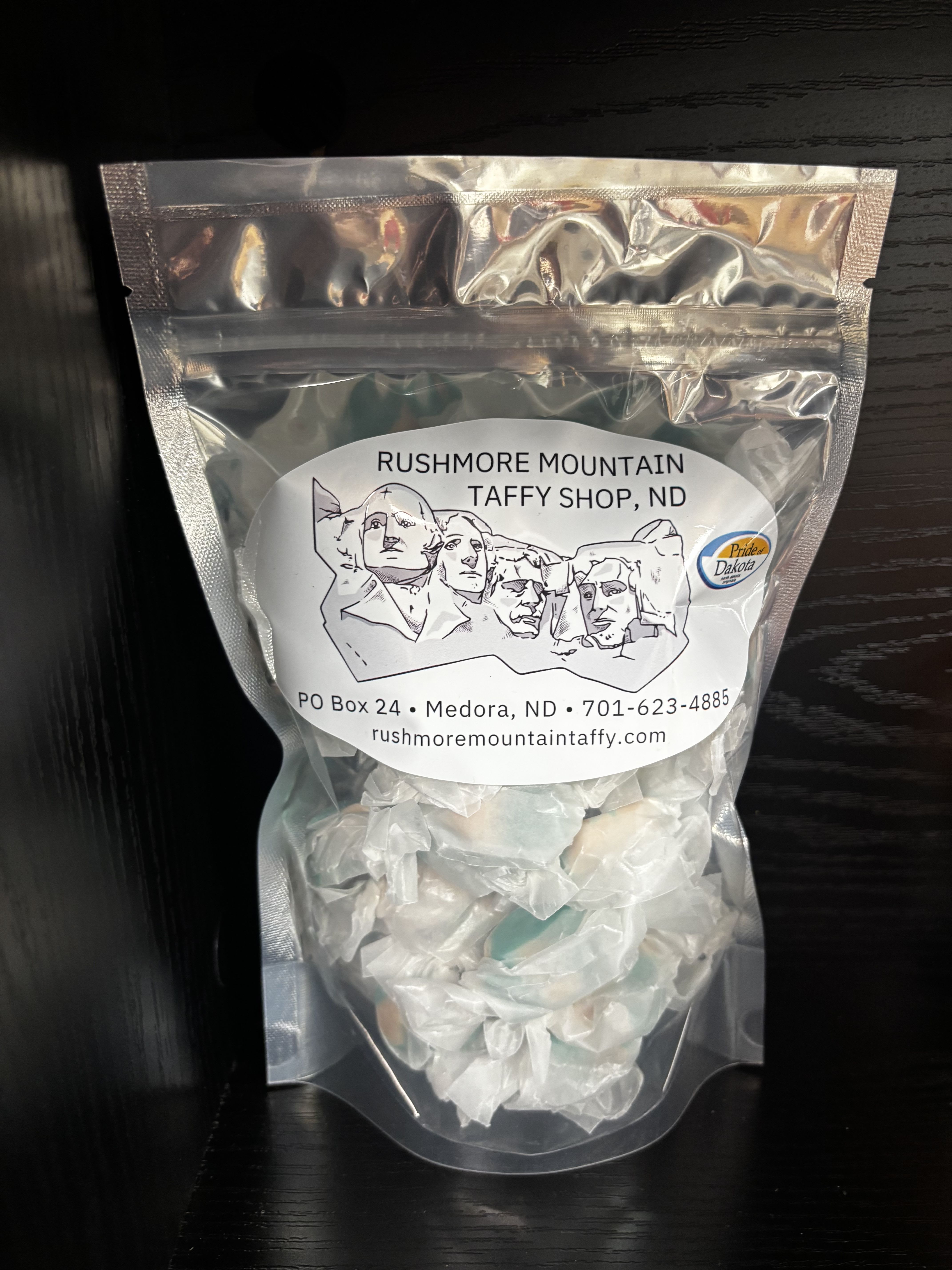 Clear bag of white taffy candy with a Mount Rushmore label