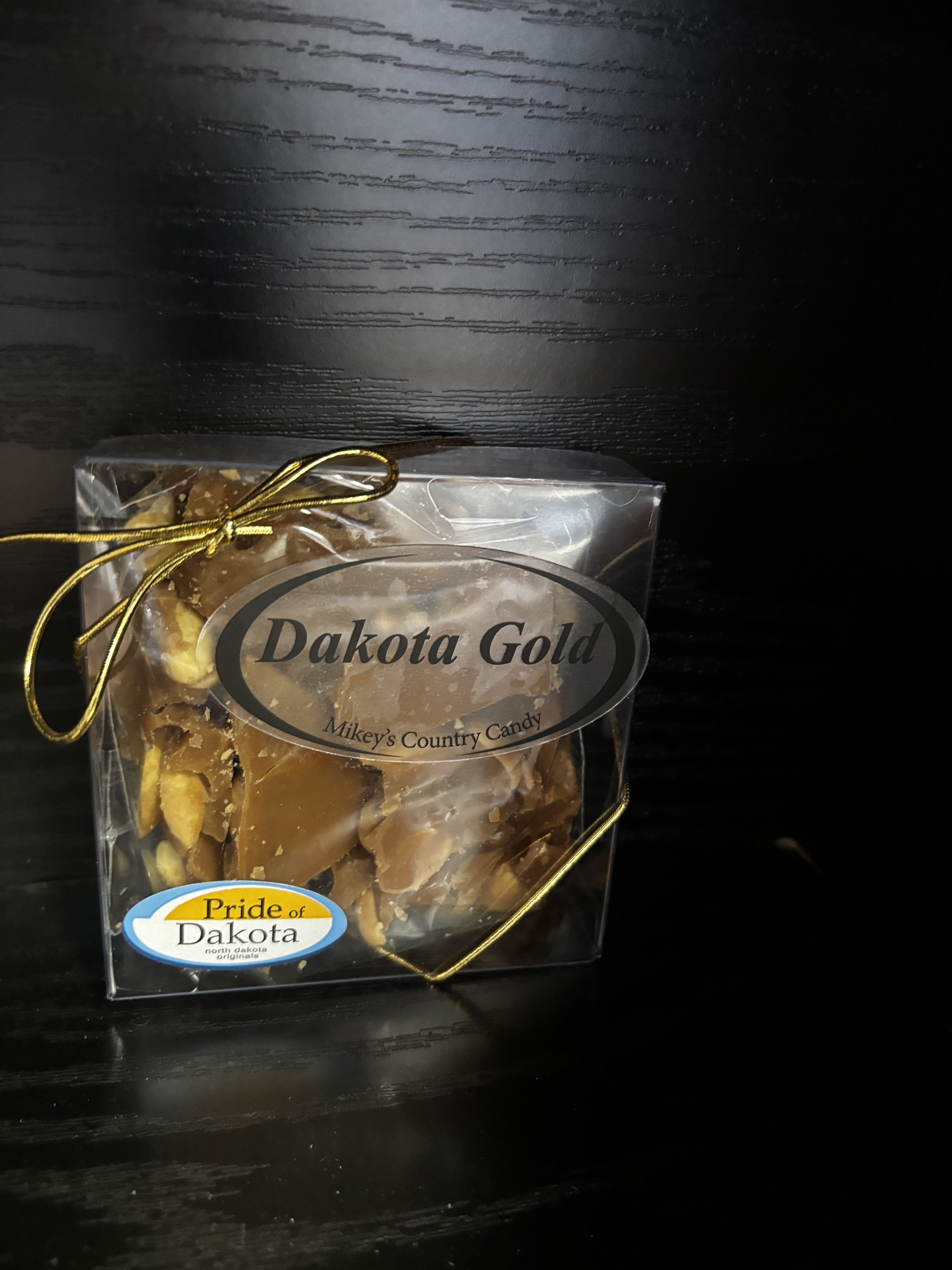 Boxed candy with a gold ribbon and label