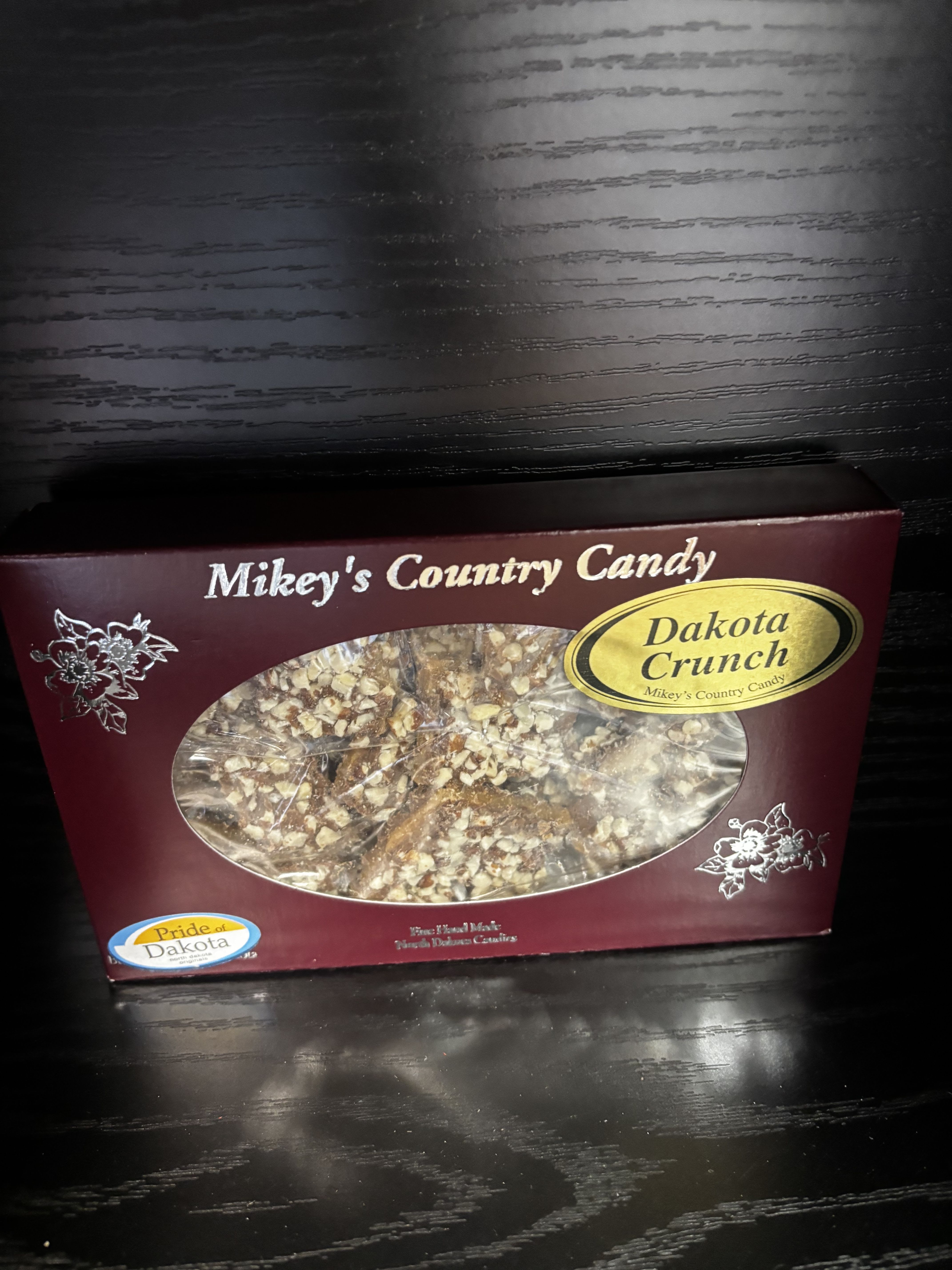 Box of Dakota Crunch candy on a dark table