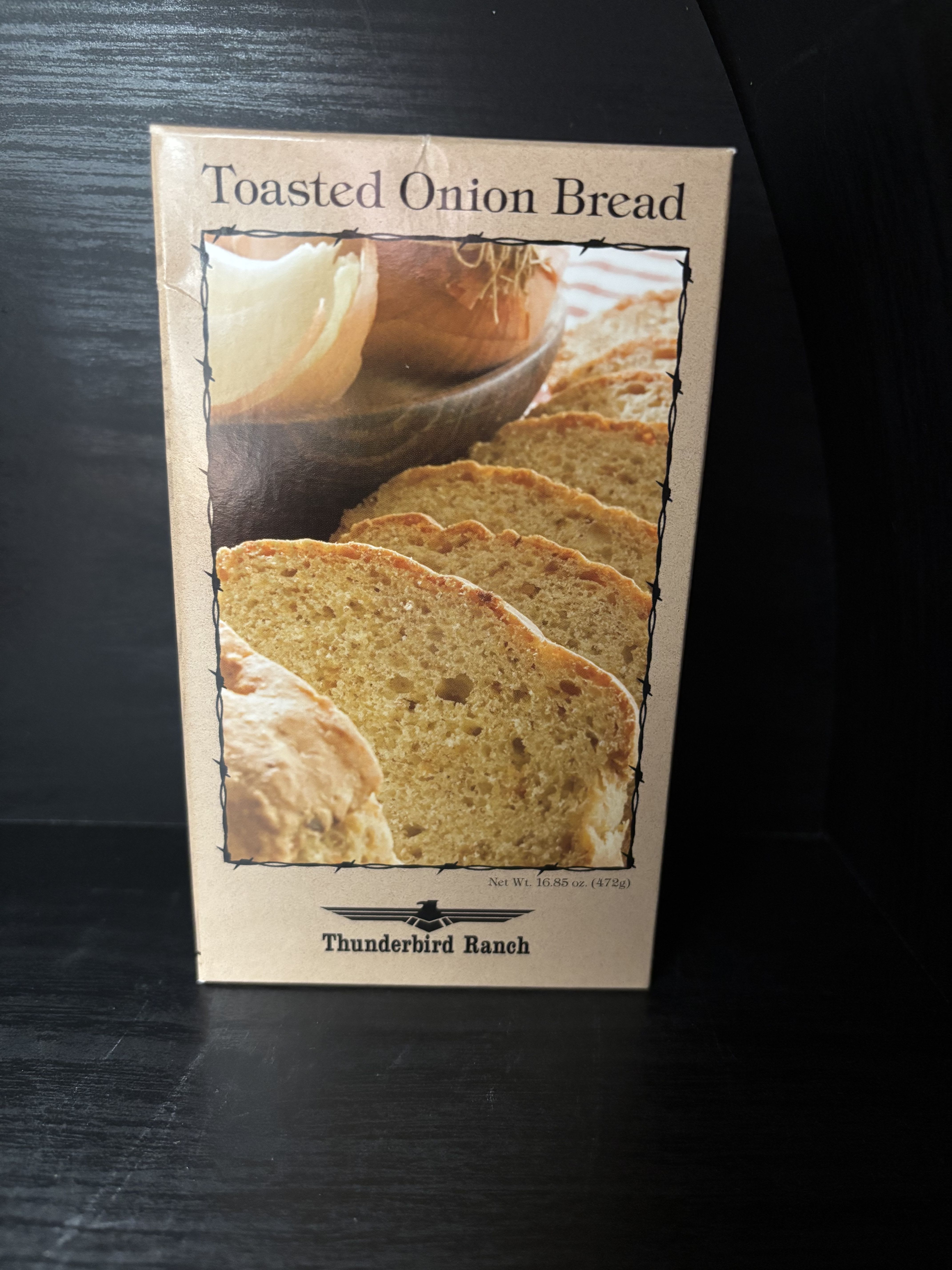 Box of toasted onion bread on a dark surface