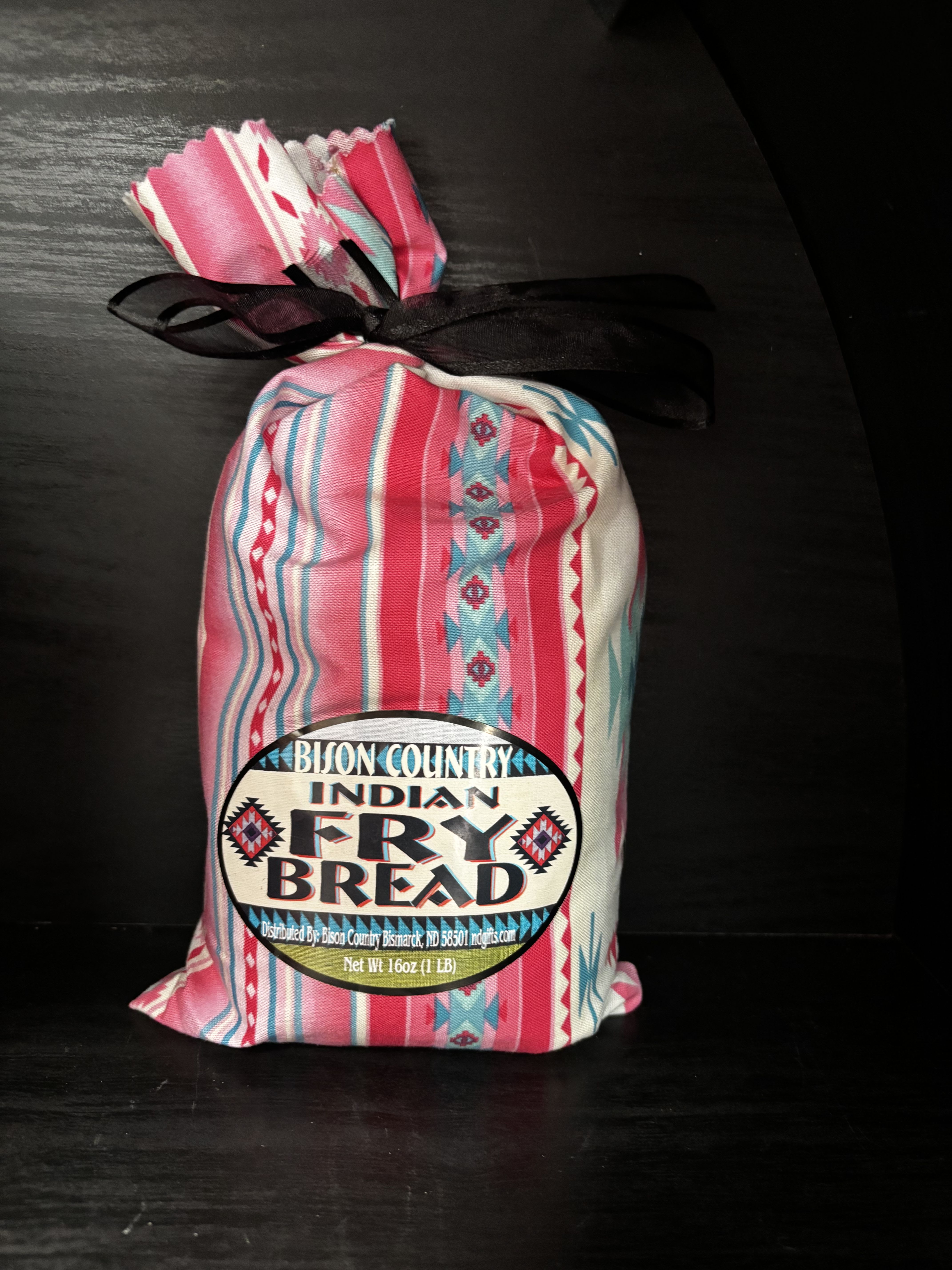 Bag of Indian fry bread mix tied with a black ribbon