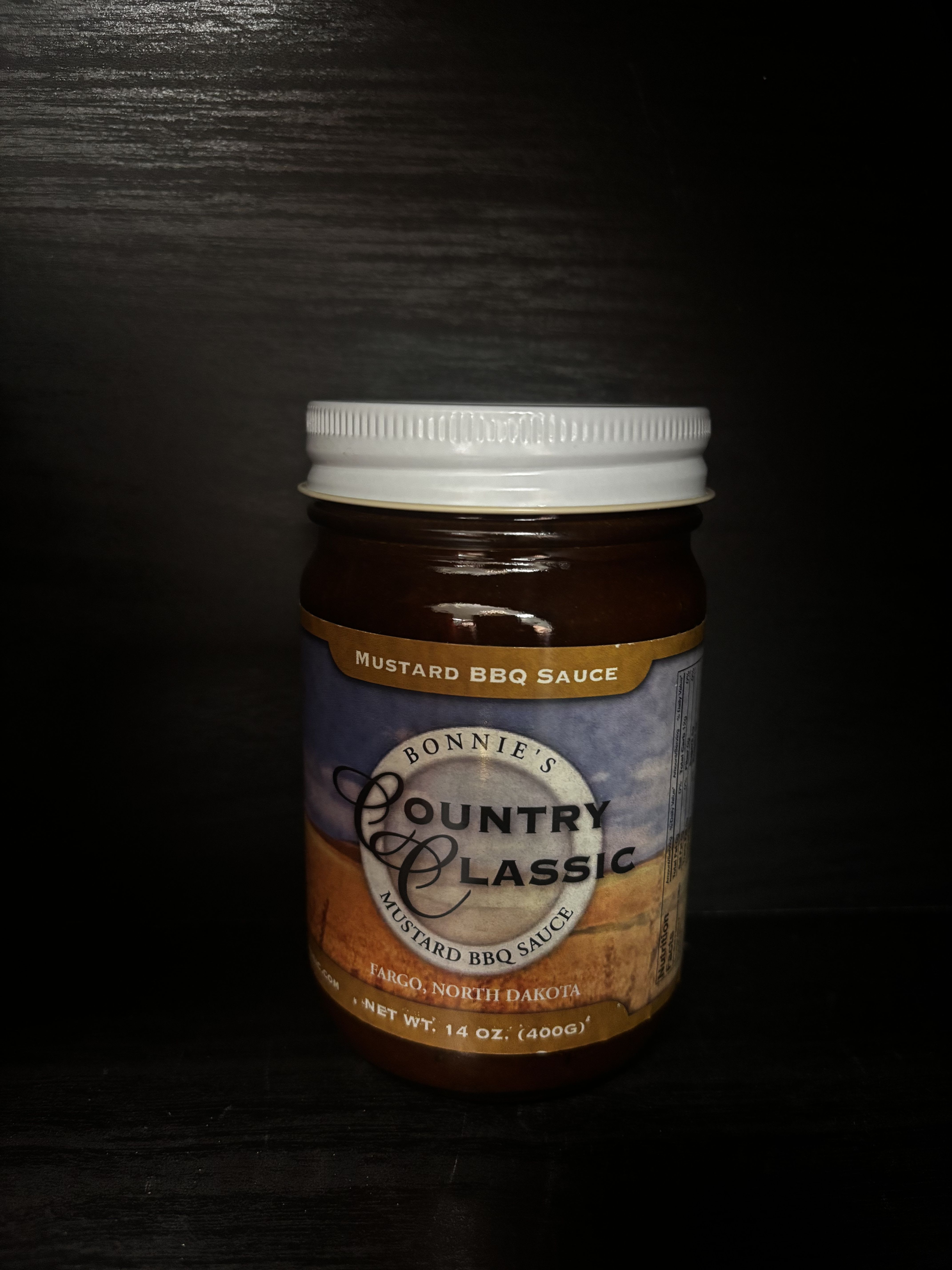 Jar of mustard BBQ sauce with a white lid