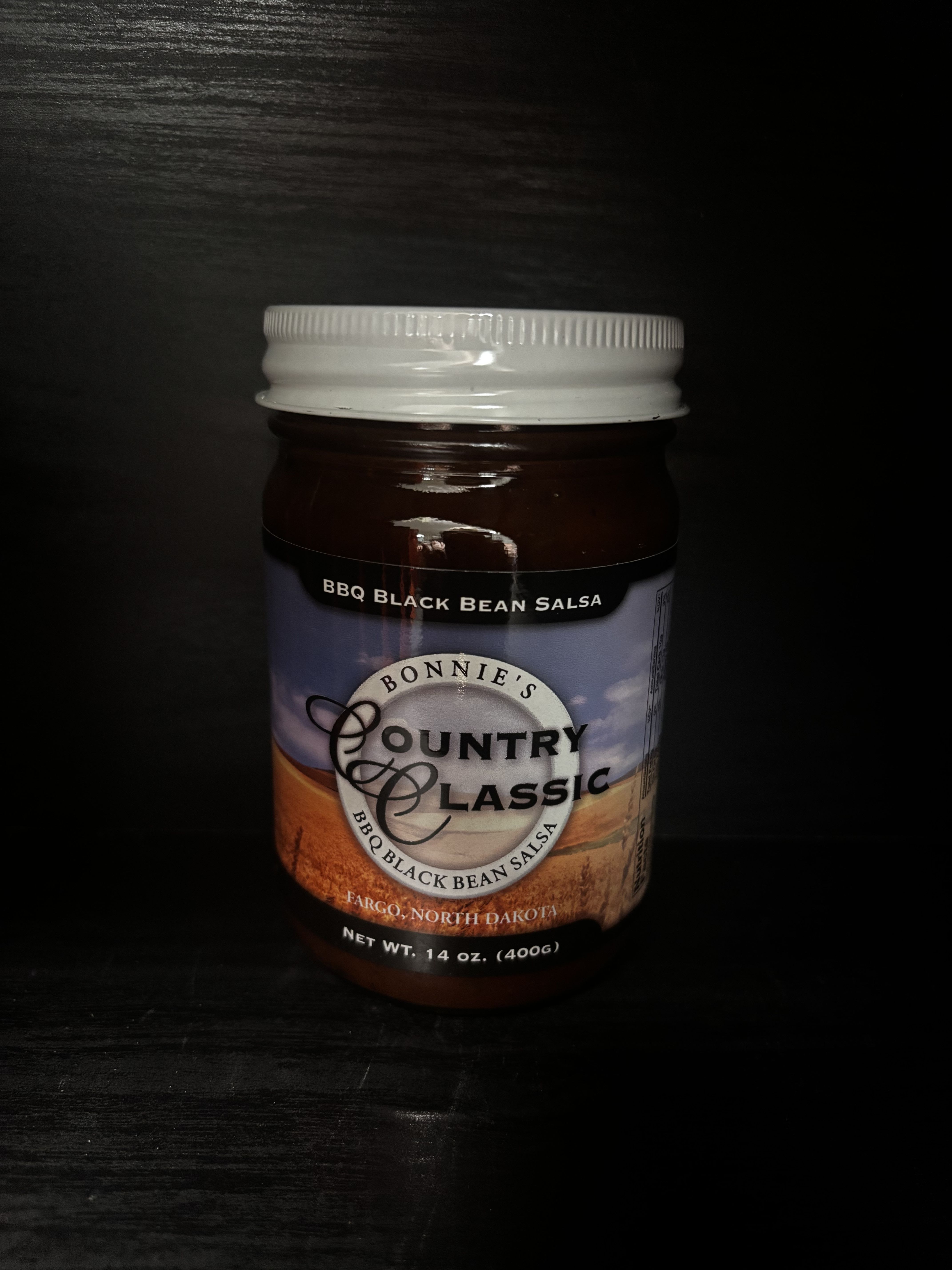 Jar of BBQ black bean salsa with a white lid