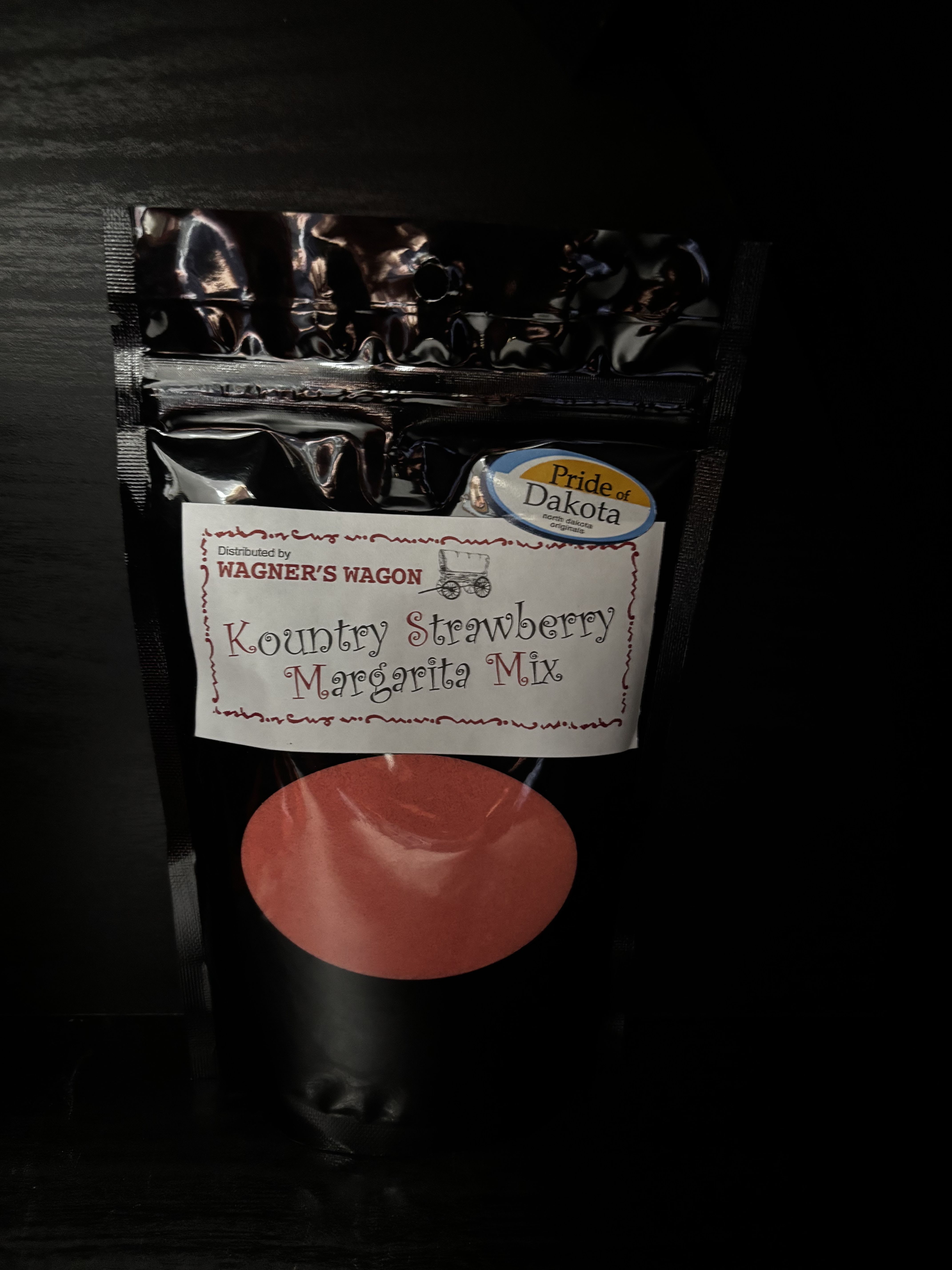 Black pouch of Kountry Strawberry Margarita Mix with a red circle label