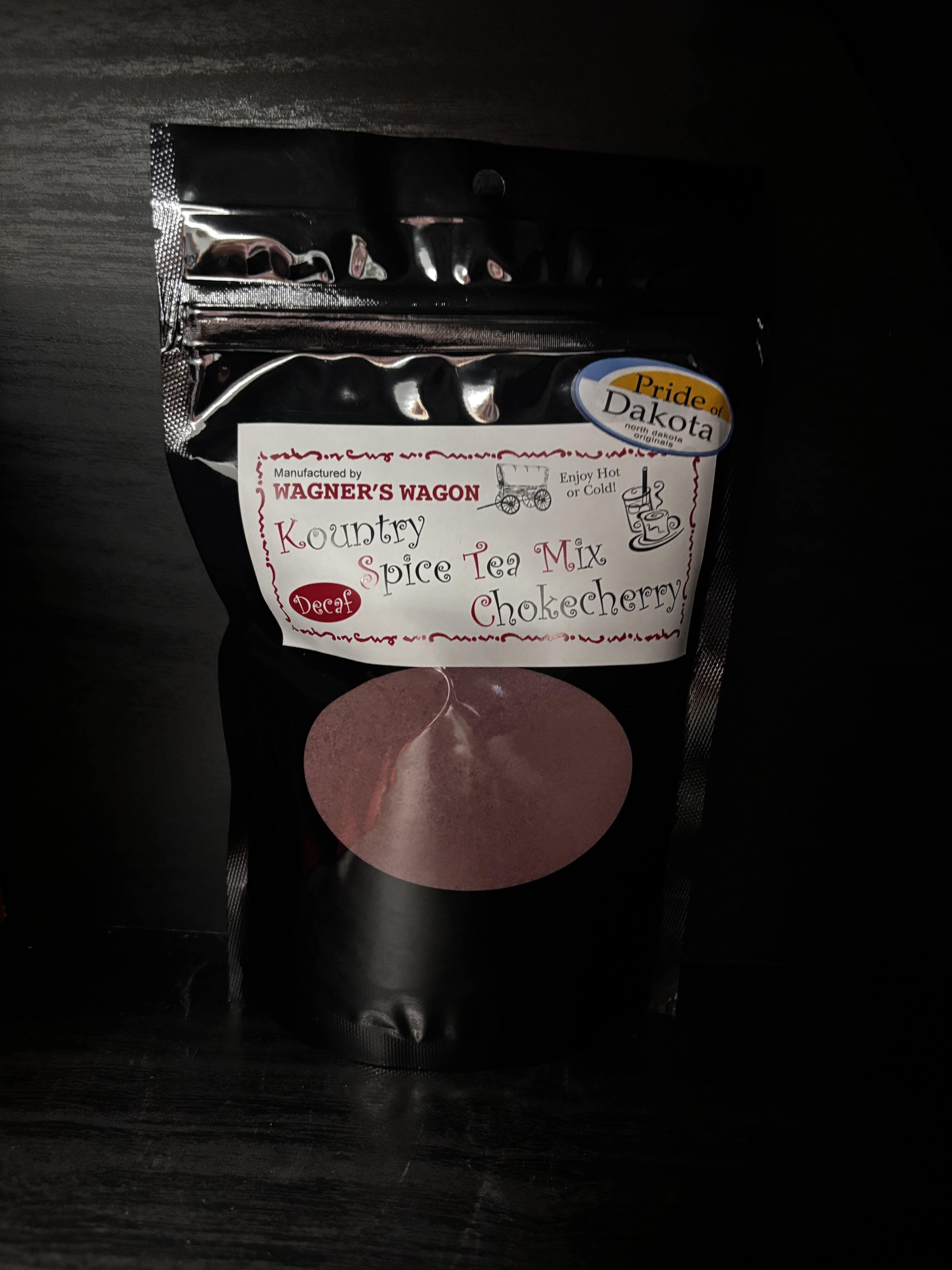 Black pouch of Kountry Spice Tea Mix with a label and circular window