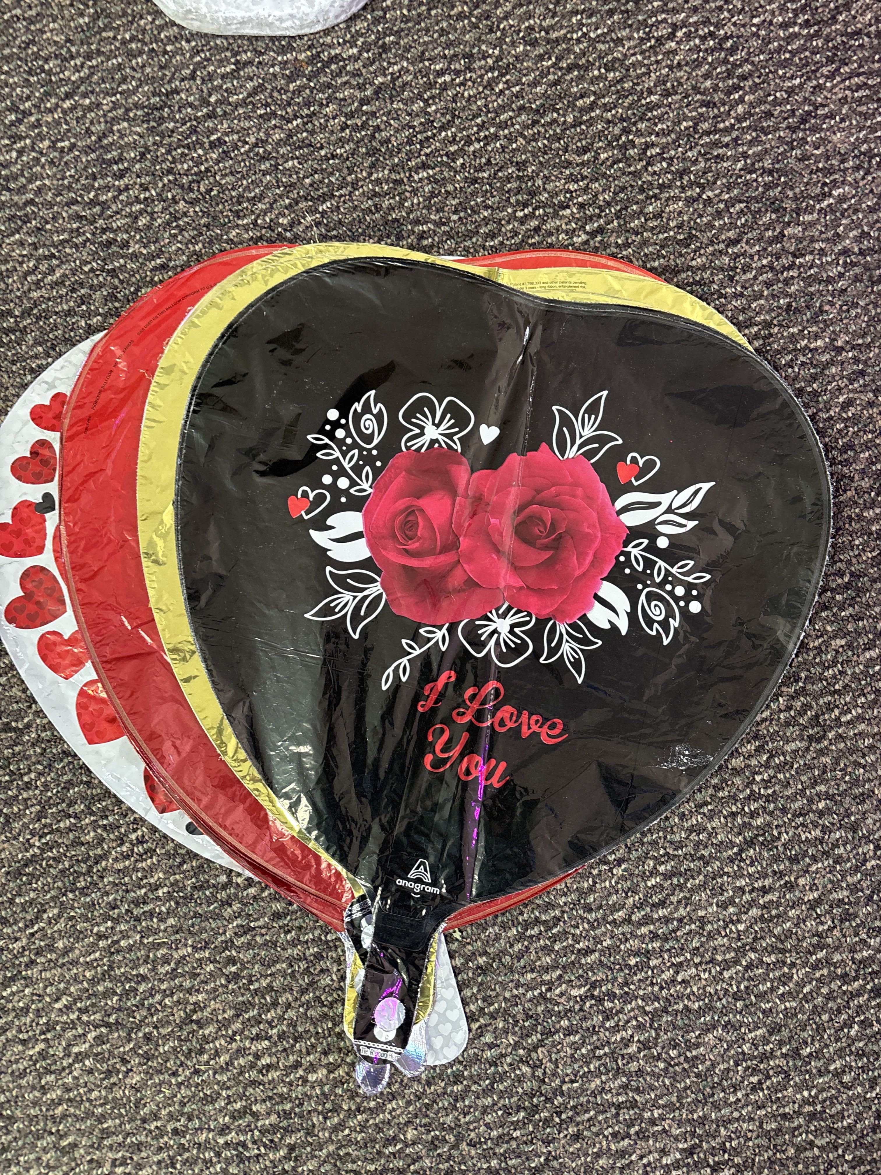 Heart-shaped balloon with red roses and "I Love You" text