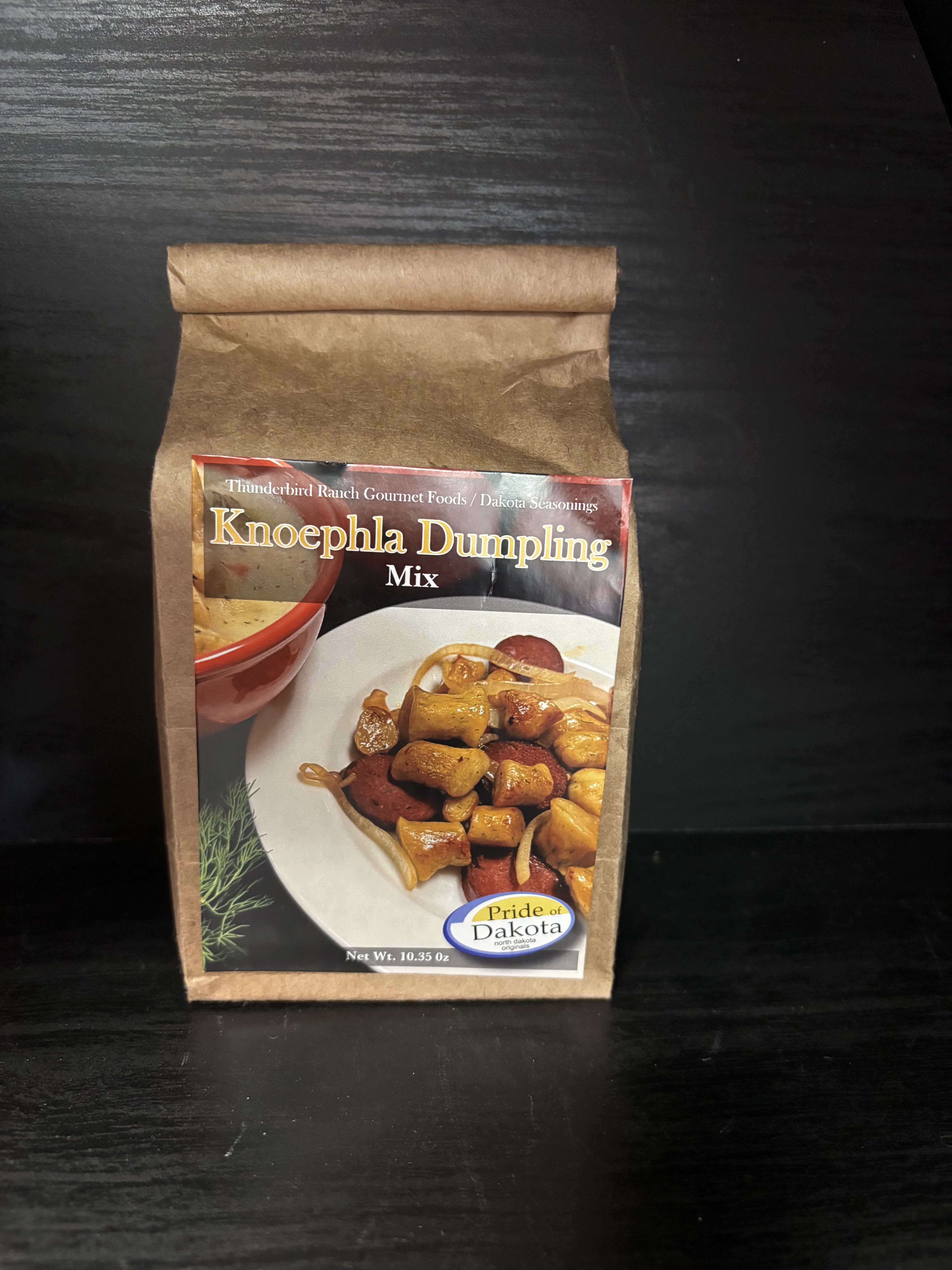 Brown paper pouch of Knoephla Dumpling Mix on a dark surface