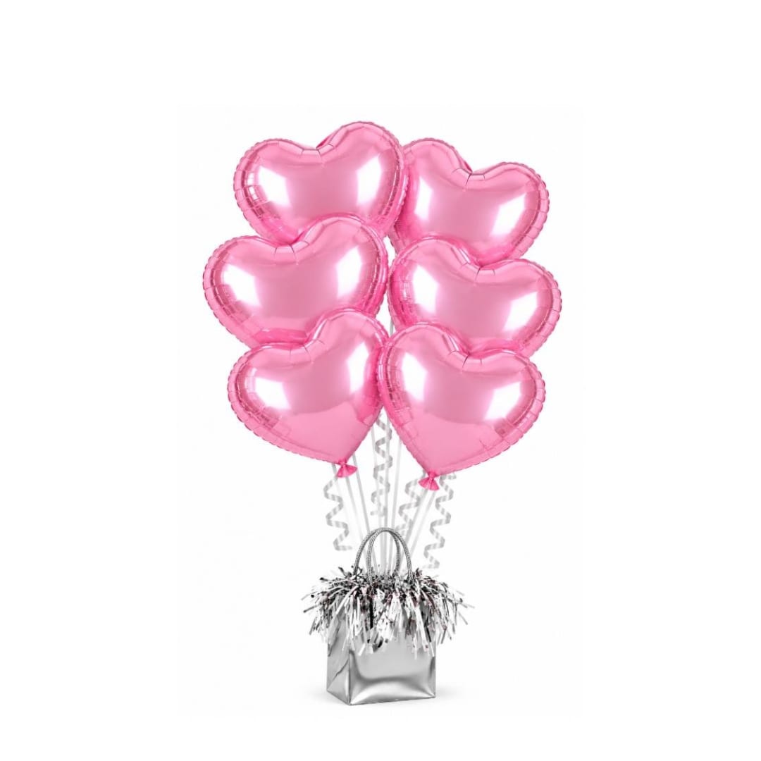 Pink heart-shaped balloons in a silver gift bag with curly ribbons