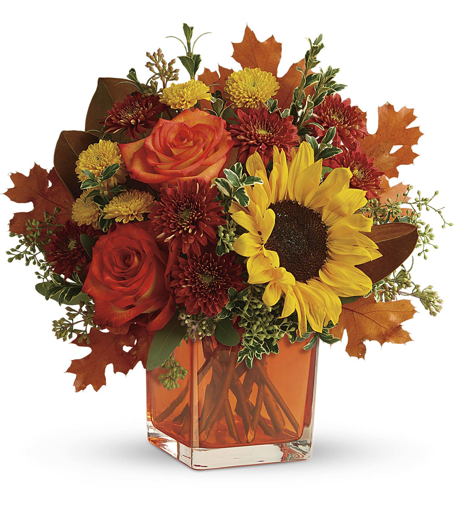 Autumn bouquet of roses, sunflowers, and mums in an orange glass vase