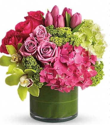 Pink roses and tulips with hydrangea in a glass vase