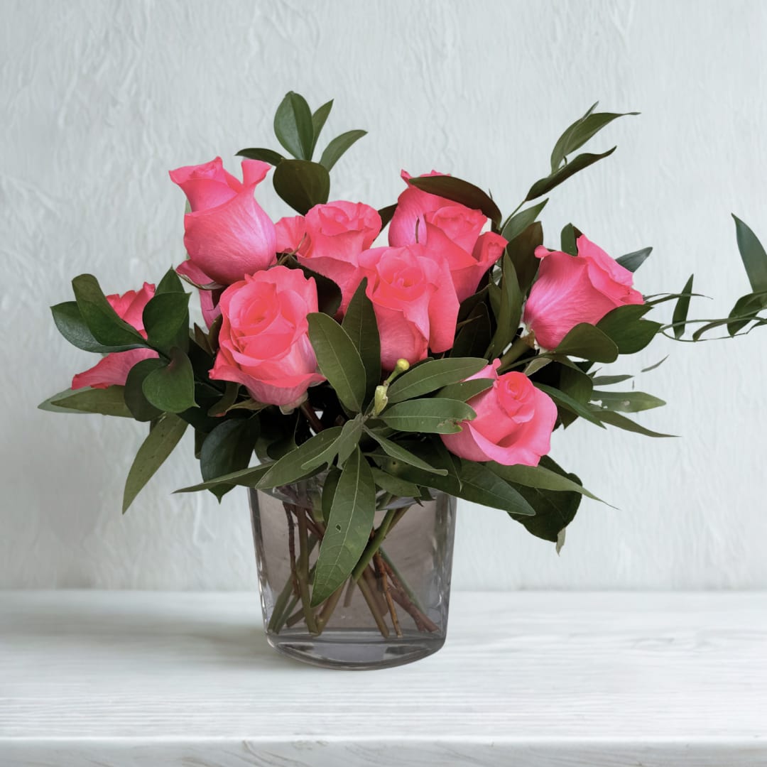Pink roses arranged in a clear glass vase
