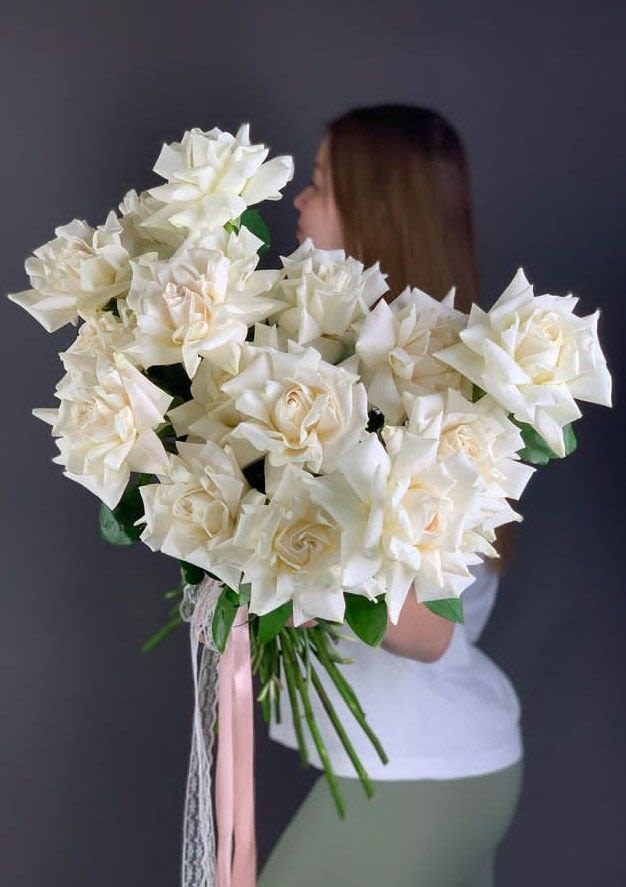 Ivory promise  - A timeless bridal bouquet made of lush ivory roses, soft, romantic, and effortlessly elegant. Hand-tied with flowing ribbons, this bouquet feels classic yet modern perfect for brides who love clean beauty with a touch of drama. It’s full, airy, and photographs like a dream.  Think: walking down the aisle, sunlight on white petals, and that “wow” moment when everyone turns.