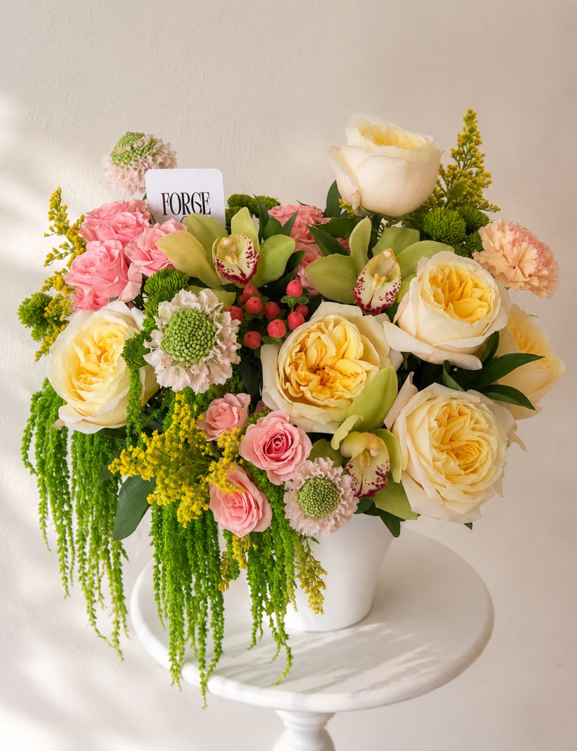 Wild elegance- orchid, amaranth, garden roses.  - A fresh and elegant arrangement featuring premium garden roses, orchids, delicate scabiosa, spray roses, carnations, and seasonal blooms in soft shades of ivory, blush, and green. Designed with flowing greenery and cheerful golden accents, this piece brings a natural garden-inspired feel that’s perfect for birthdays, celebrations, thank-you gifts, or simply brightening someone’s day.  Please note: Some flowers may be substituted with blooms of equal or greater value depending on seasonal availability while maintaining the overall style and color palette. 