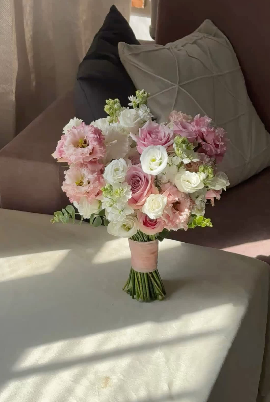 Pink and white bridal bouquet with roses and ruffled blooms