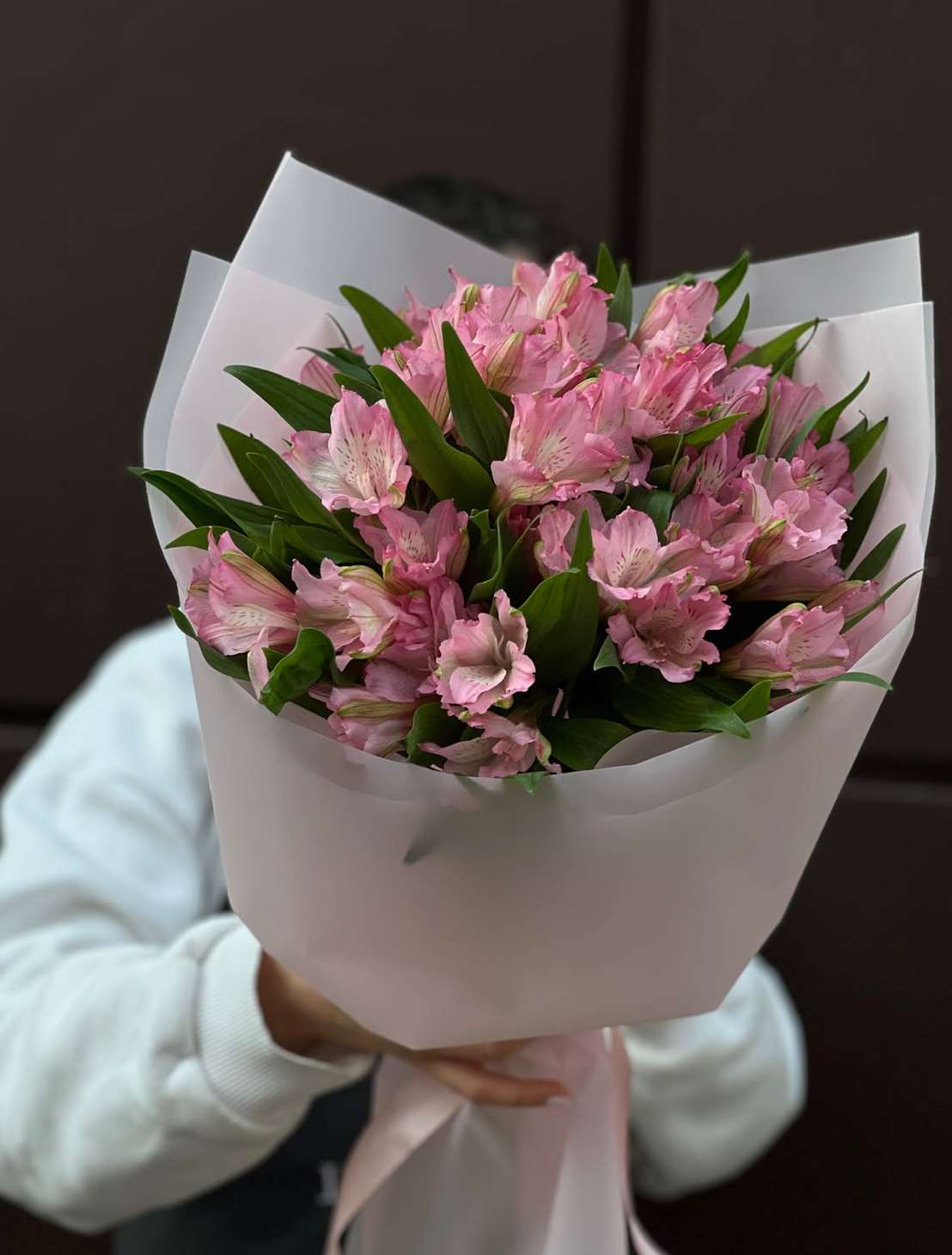 Bouquet of pink alstroemeria wrapped in white paper
