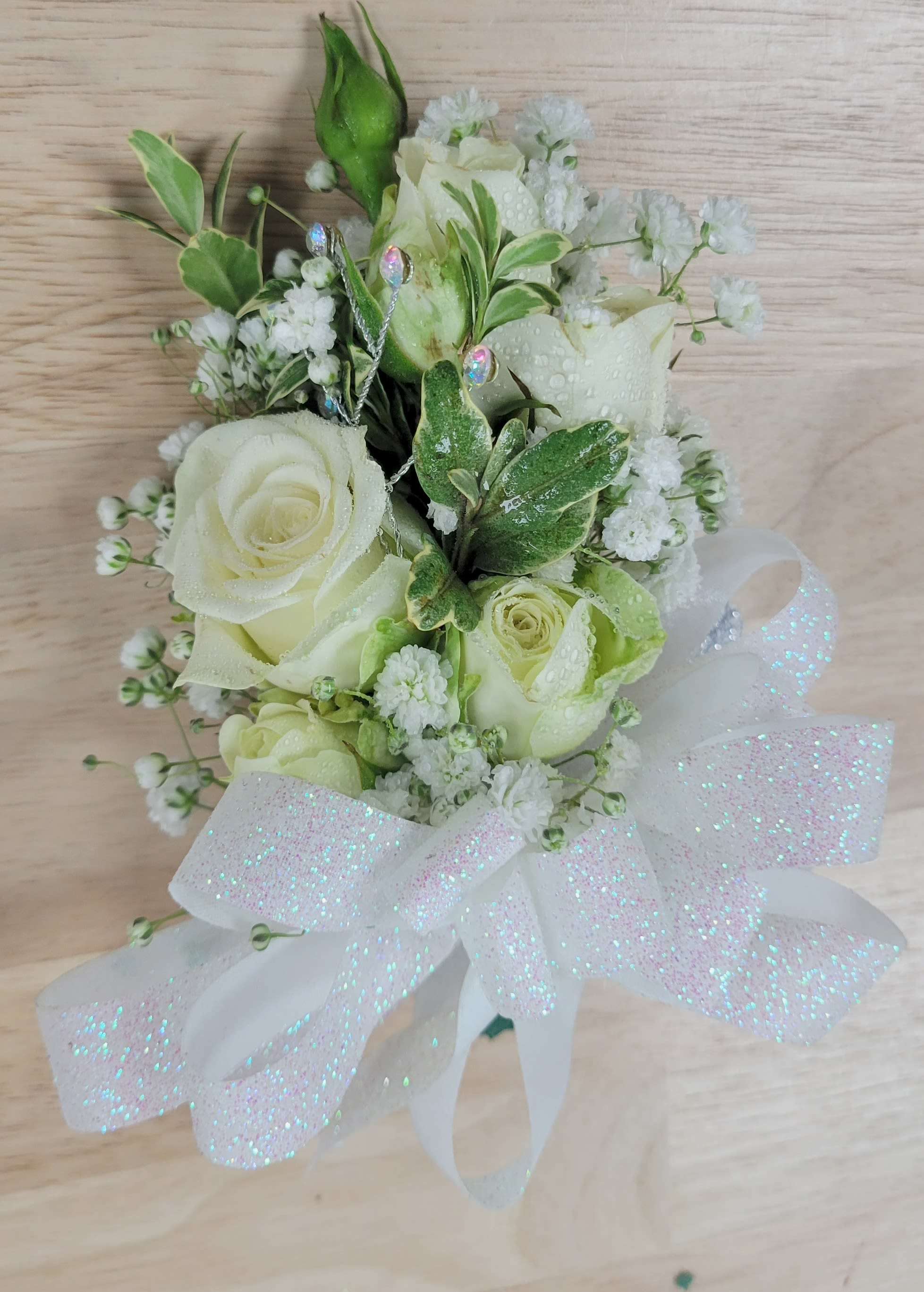 White rose bouquet with baby's breath and a large sheer ribbon