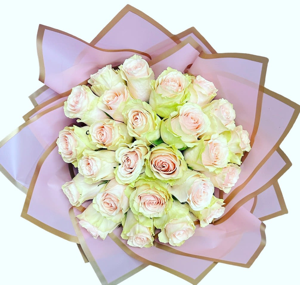 Bouquet of pale pink roses wrapped in lavender paper