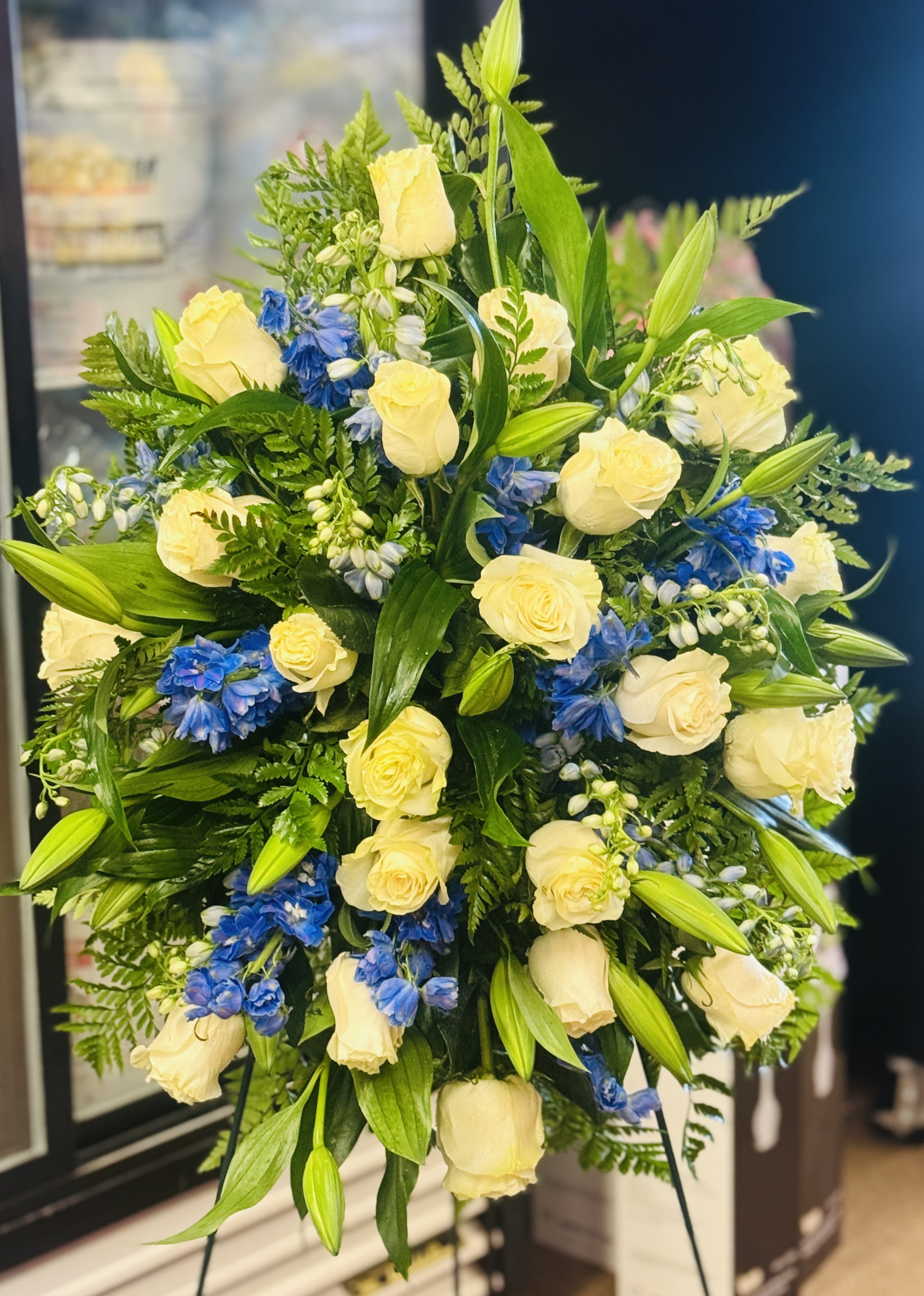Bouquet of cream roses and blue flowers with lily buds