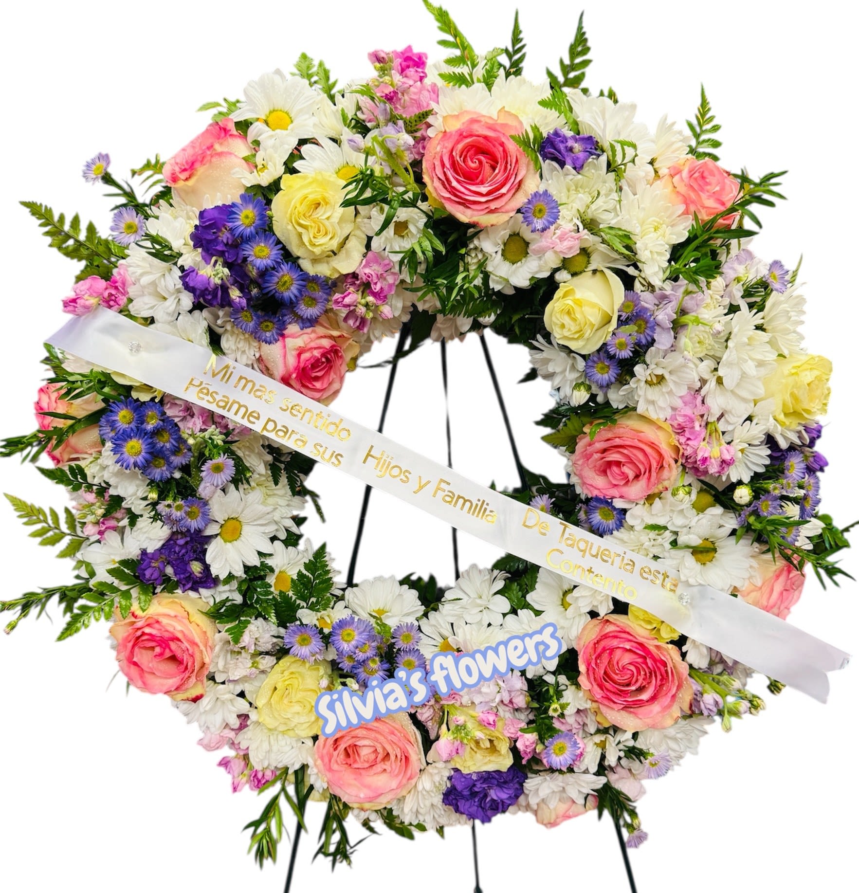 Heart-shaped floral wreath with pink roses, white daisies, and purple flowers