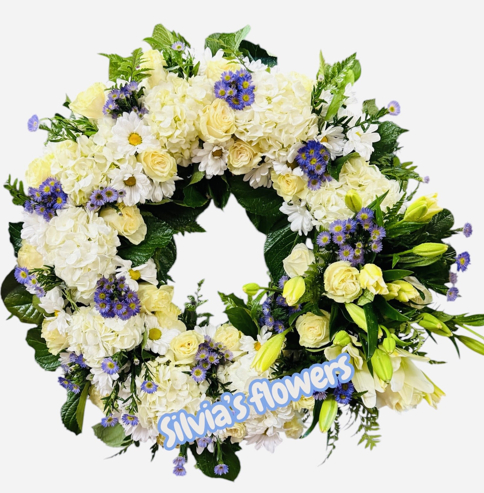 Circular floral wreath with white and pale yellow flowers and purple accents