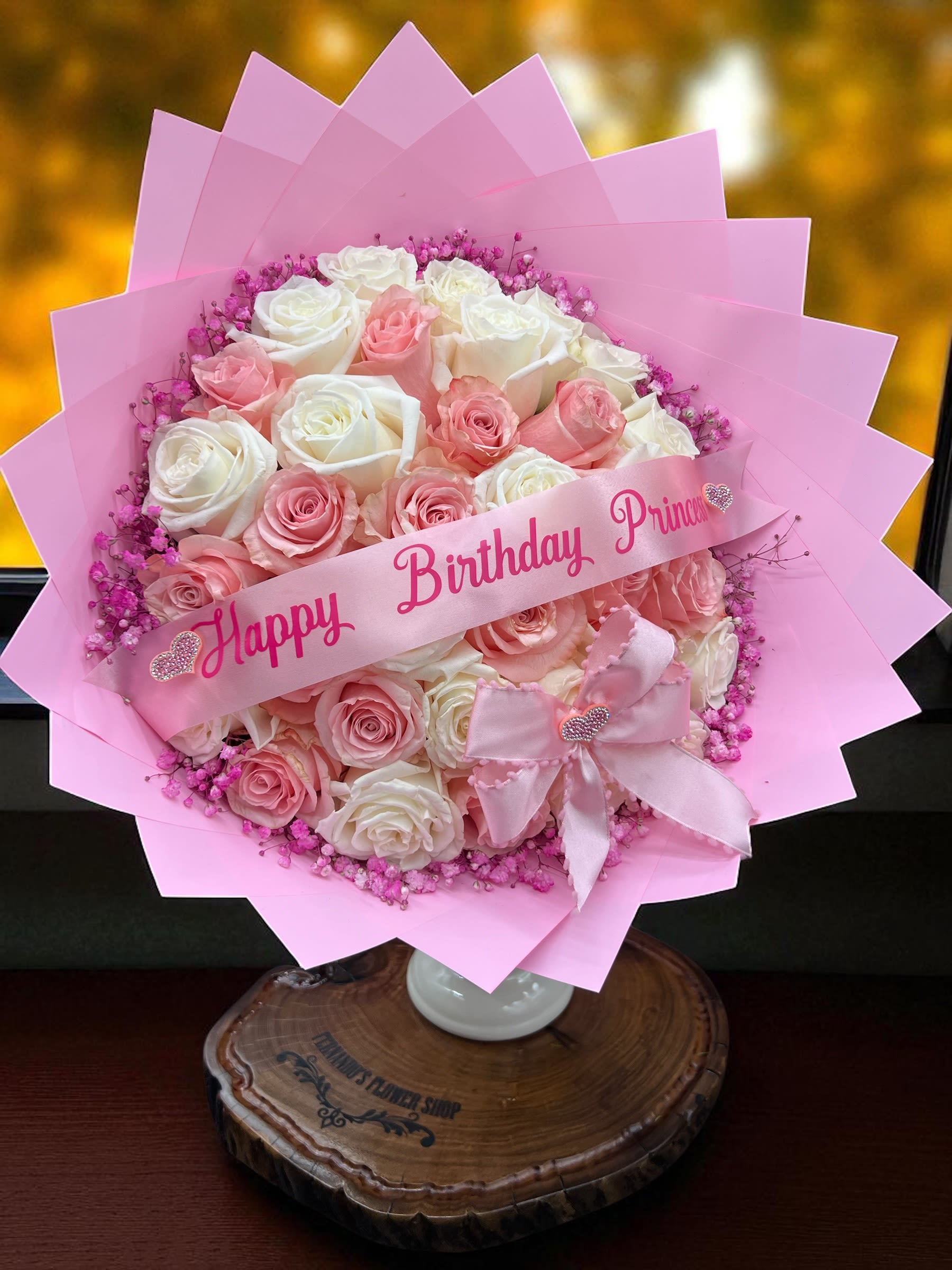 Princess - Happy Birthday Princess!  Celebrate her special day with this elegant bouquet of soft white and blush-pink roses, accented with delicate pink filler blooms and wrapped in pastel pink paper. Finished with a sweet bow and a custom ribbon message, this arrangement is the perfect way to make your princess feel loved and cherished on her birthday.   40 Roses Banner $10