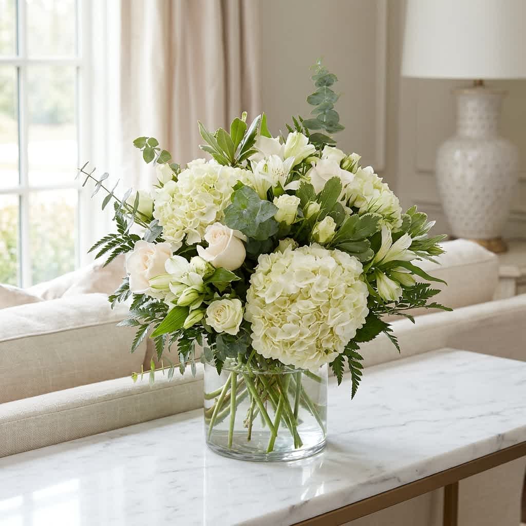 Cloud Nine (DL) - New beginnings deserve flowers! This all white arrangement includes roses, lisianthus, white spray roses and hydrangeas. Cloud Nine is the perfect gift for celebrating a new year, a new baby, or a newly married couple. 