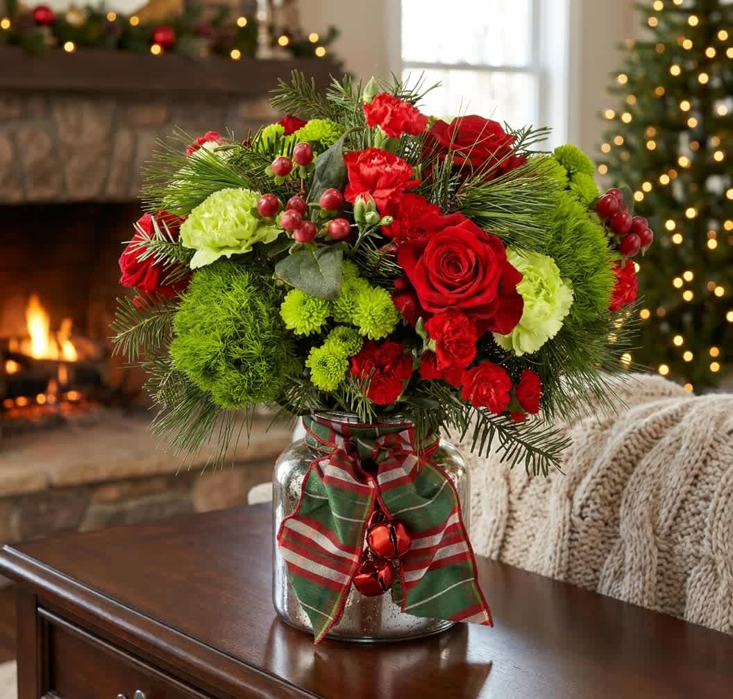 Jingle Bells (DL) - Bright red roses and carnations set a festive tone in this holiday flower arrangement, perfect as a Christmas centerpiece or a cheerful winter gift. The mix of lime-green chrysanthemums and textured evergreen sprigs gives lively contrast and a seasonal evergreen scent, while the hanging decorative bells add a playful, charming finish your recipient will notice right away.  