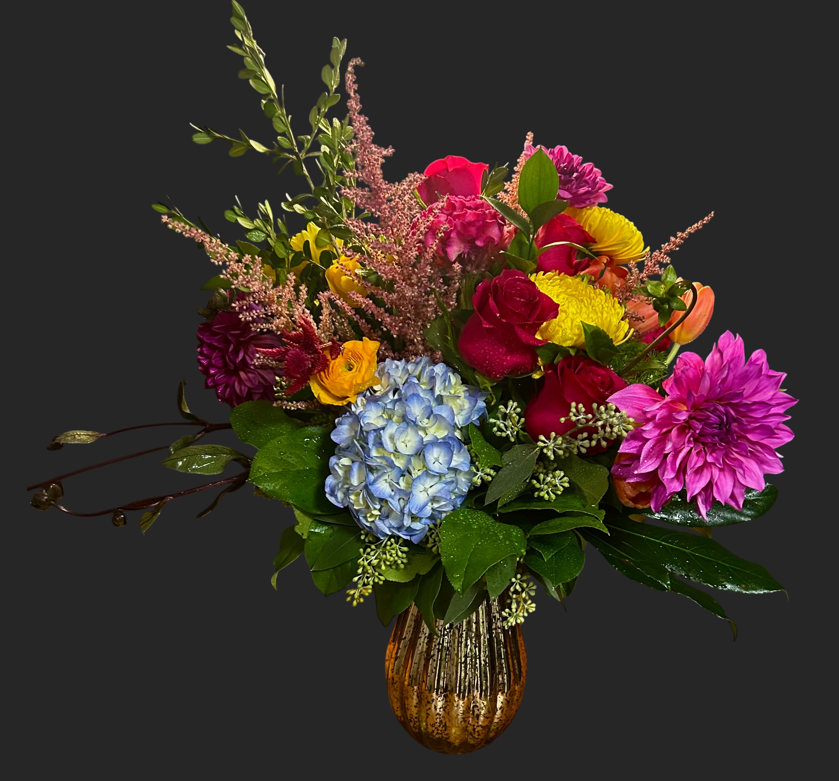 Colorful mixed bouquet in a gold vase with hydrangea and dahlias