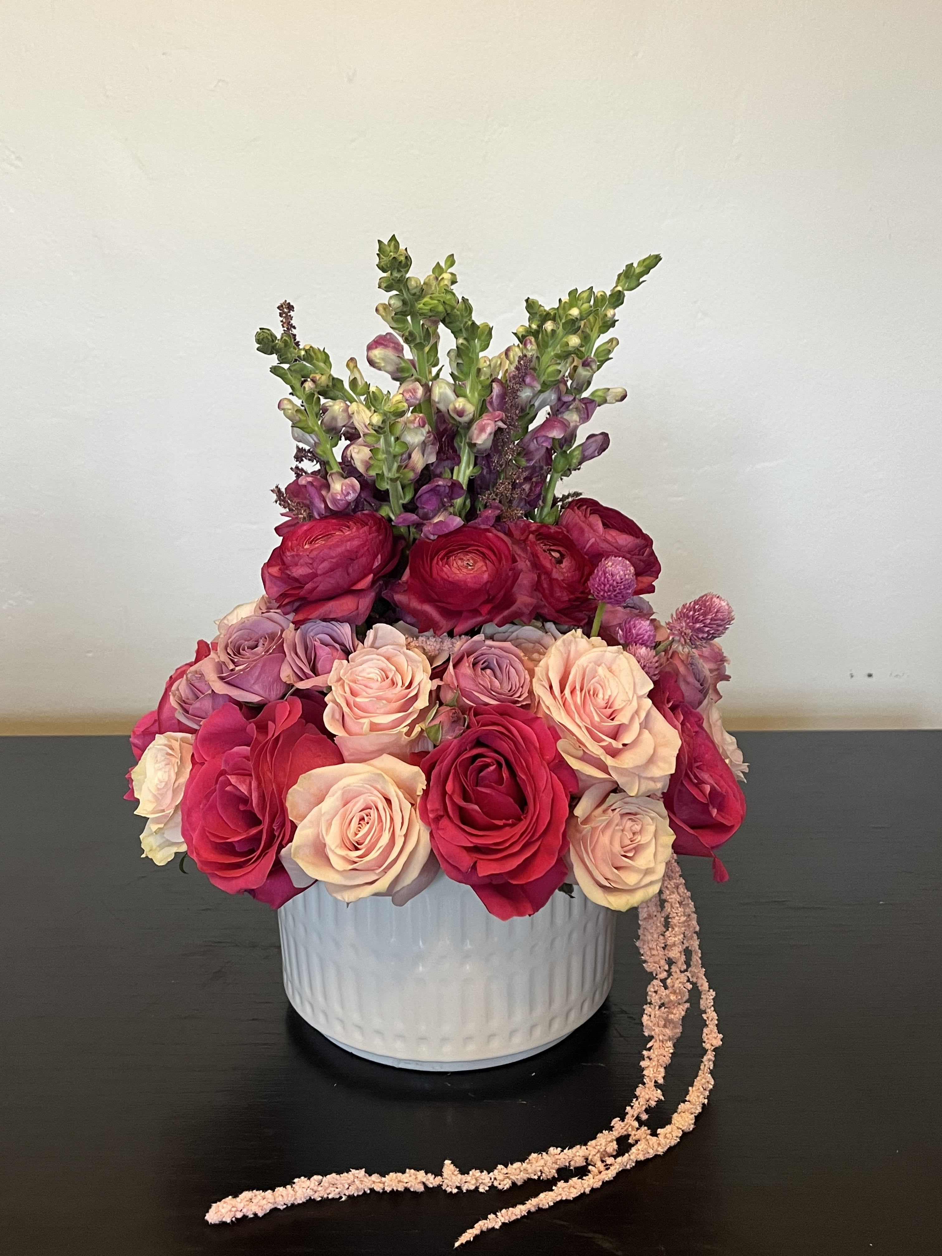Pink slushy -  mix of garden roses and ranunculus in varying shades of pink and fuchsia 