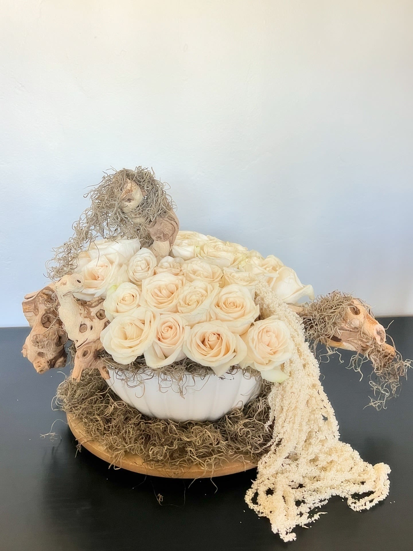 Driftwood Dreams - White roses, moss and a statement branch makes this arrangement the perfect gift for any occasion.