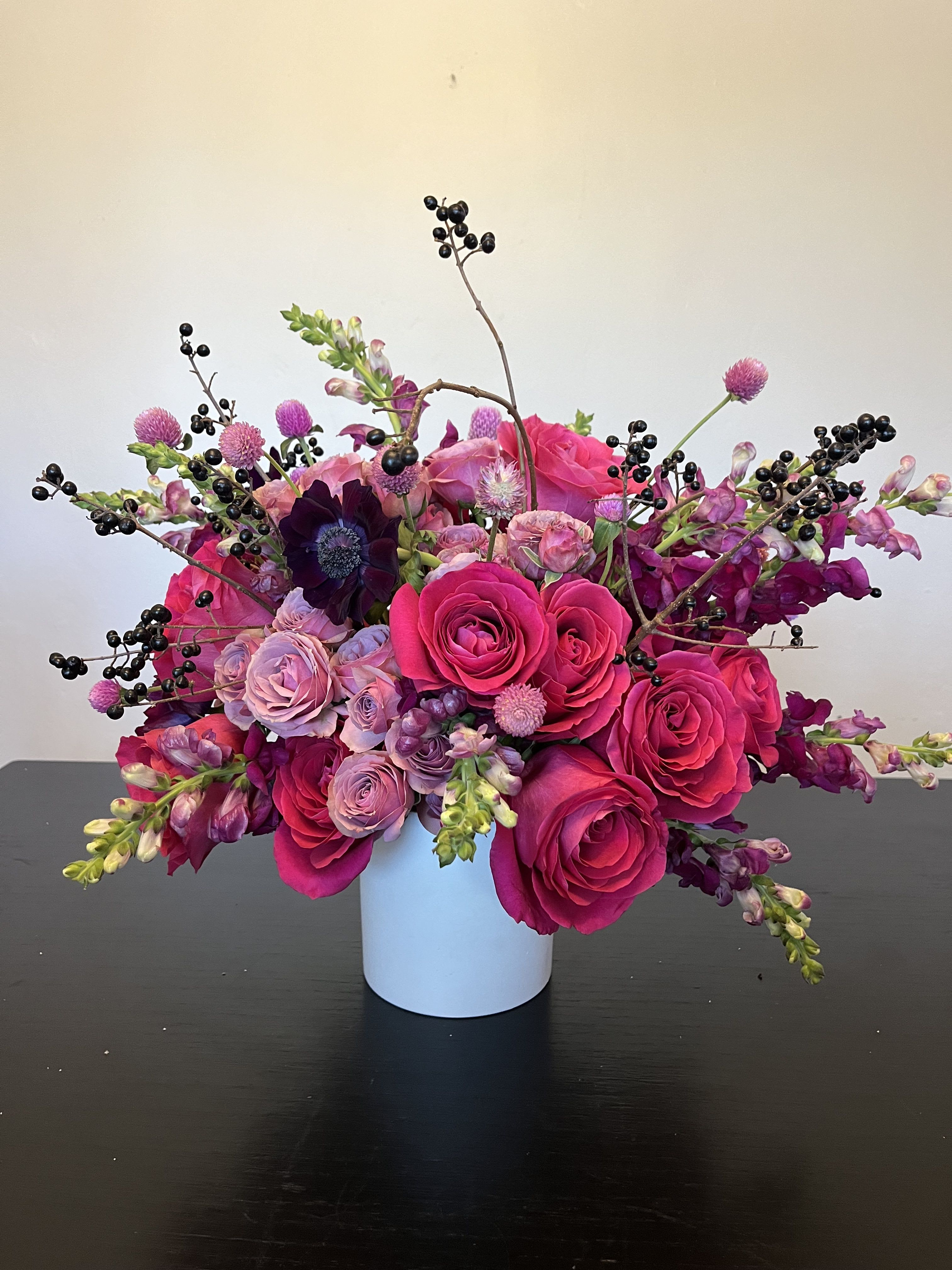 Blossom Boulevard - bright pink roses combined with soft pink spray roses and wild berries. 