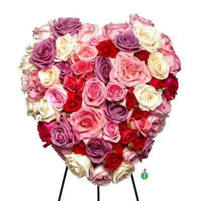 Heart-shaped bouquet of pink, purple, red, and white roses