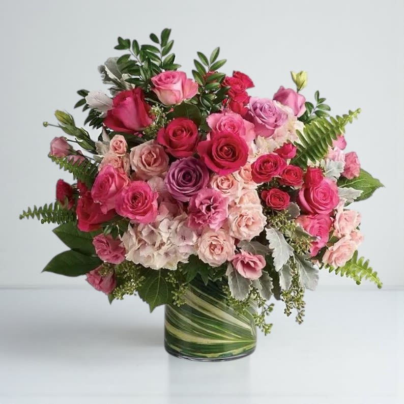 Pink and red rose bouquet in a glass vase