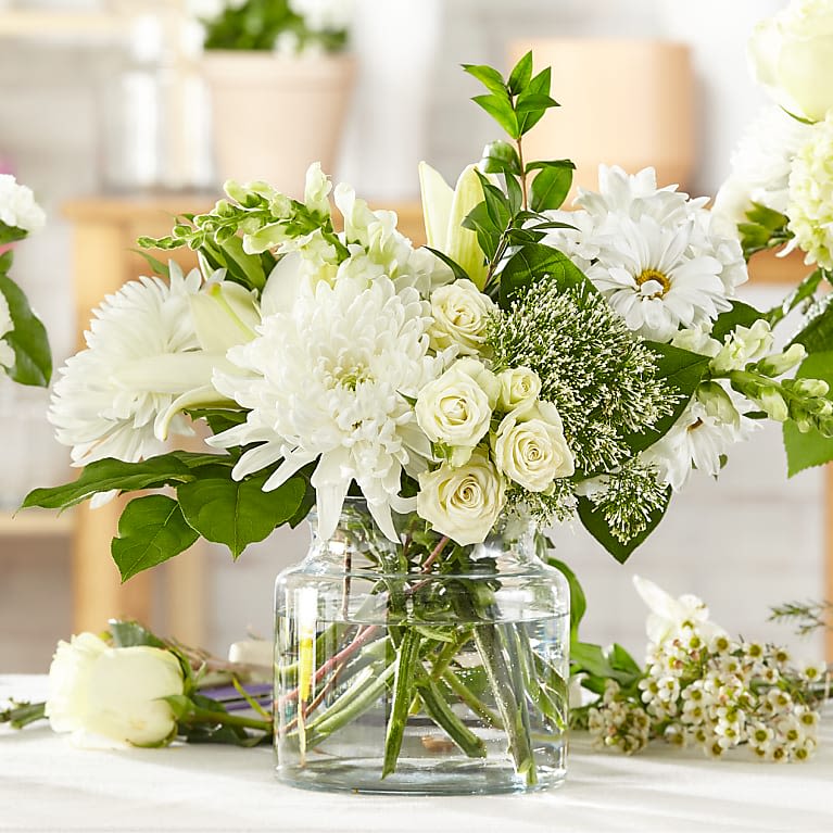 White flowers arranged in a clear glass vase