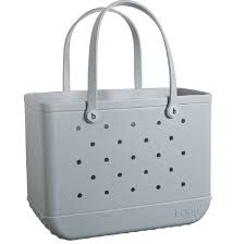 Bogg Bag Original - Shade Of Grey - The bag that started it all—washable, indestructible, and built to carry it all. The Original Bogg Bag is our largest, most spacious tote—perfect for beach days, big hauls, and everyday family adventures.  Durable and tip-proof, it stands upright, wipes clean, and keeps up with whatever your day throws at it. Sand brushes off. Spills don’t stick.  Includes two clear insert bags—perfect for organizing smaller essentials like your phone, sunscreen, keys, or snacks.  Pair it with our full line of Bogg accessories—dividers, toppers, coolers, makeup bags, and more—to build your ultimate carryall kit.  Best for: Beach trips, travel days, family outings, and everything in between.