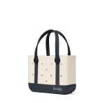 Bogg Bag Bitty - Oxford Blue - Small but mighty. The Bitty Bogg Bag is our most compact tote—perfect for kids, snacks, small essentials, or even as a stylish lunch tote. It’s tip-proof, durable, and fully washable—just like our larger bags, but in a mini size made for quick trips and light hauls.  Great for Mommy &amp; Me moments or anyone who loves a grab-and-go option with serious charm.  Includes a small clear pouch for storing little essentials like keys, lip balm, or hand sanitizer.  Best for: Kids, lunches, snacks, small items, quick errands.