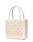 Cream tote bag with cutout floral pattern and long handles
