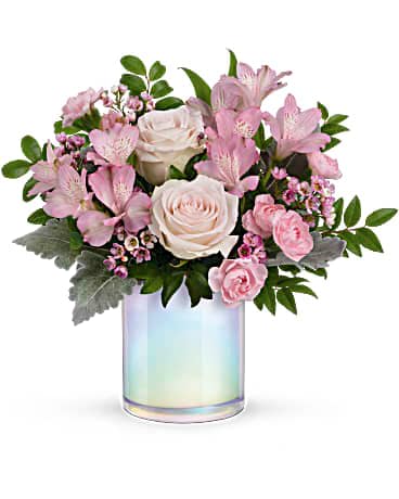 Teleflora's Pretty As A Pearl Bouquet - The shimmering iridescent finish of this white glass vase brings a touch of magical whimsy to this blushing rose bouquet. This beautiful bouquet features light pink roses, pink alstroemeria, miniature pink carnations, pink waxflower, dusty miller and huckleberry. Delivered in a Wonderful Whimsy cylinder.