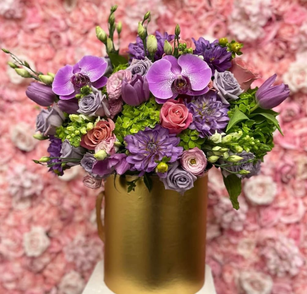 Purple and pink bouquet in a gold vase