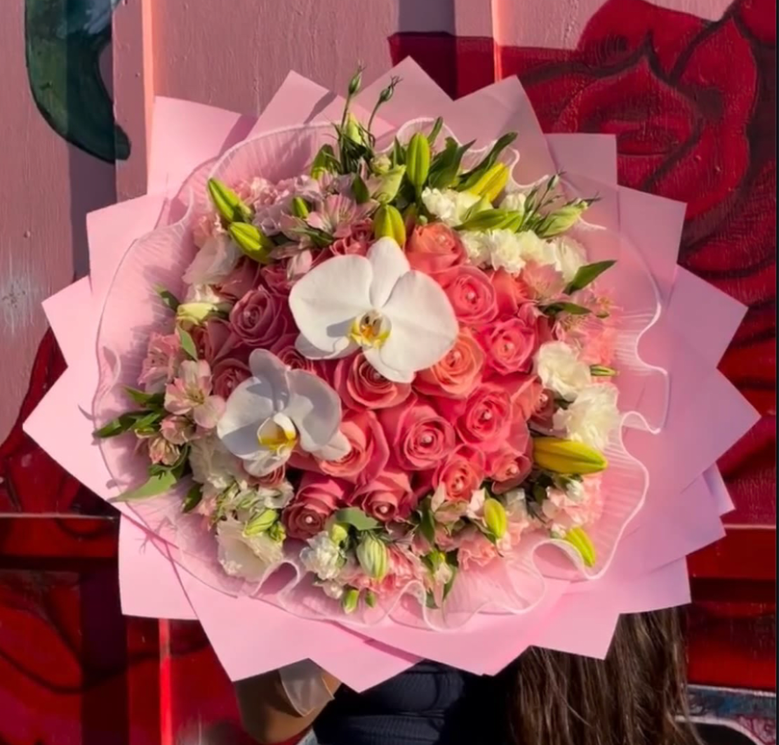 Pretty in pink buchón - 25 pink roses with a lisianthus and lily border, decorated with pearl pins and topped with orchids!