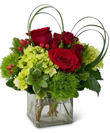 Red roses and green hydrangeas in a square glass vase