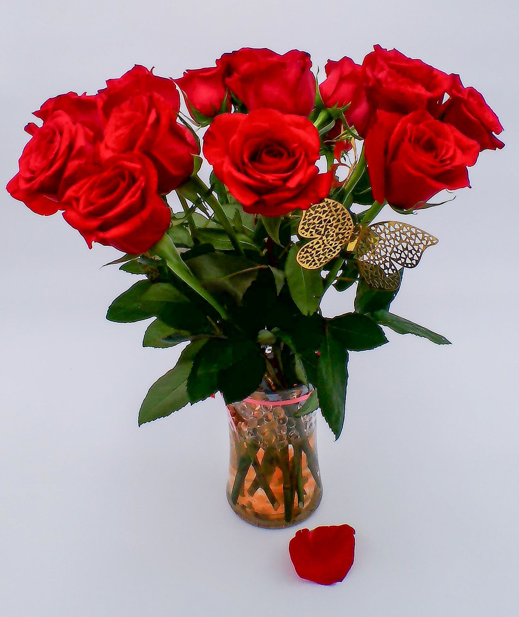 Eternal Love Rose Elegance - Romantic red rose bouquet (12 stems) arranged in an elegant vase filled with clear water beads to keep each bloom fresh and beautifully supported. Decorative vase with hydration water beads Decorative butterflies (2pc)  Weight: Approximately 500g Ideal for: romantic occasions, Valentine’s Day, anniversaries, proposals, birthdays for someone special, "I love you" surprises, apology or reconciliation gifts