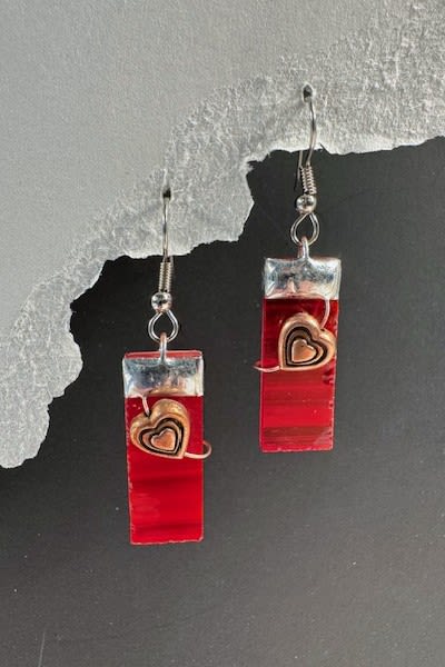 #A132 - Red Stained Glass Earrings - Glossy red rectangular drops catch the eye first - these dangle earrings read like miniature stained-glass panels, perfect as a romantic gift or a striking add-on to a floral arrangement for Mother's Day, an anniversary, or Valentine's Day. The tall red rectangles are capped in shiny silver-tone metal and accented with a layered metal heart wrapped in delicate wire, so the person you're thinking of will feel noticed and adored the moment they open the box.   Handmade-style details give these earrings modern, expressive flair: simple metal hooks let the drops swing gently, balancing bold color with wearable comfort. The red, white, and black palette makes them season-spanning-equally at home with winter holiday looks, autumn ensembles, prom or wedding accessories, and sunny spring or summer outfits-so they work for birthdays, graduations, "just because" surprises, or a thoughtful get-well or thank-you gift.   Lightweight and versatile, these dangles make a memorable standalone present or a complementary finishing touch to a bouquet for love and romance, Mother's Day, retirement, or to say "I'm sorry" or "thinking of you." Order alongside any arrangement for a complete gift that feels intentionally curated and ready to delight.  Shipping available - select Delivery, then message us to ship.