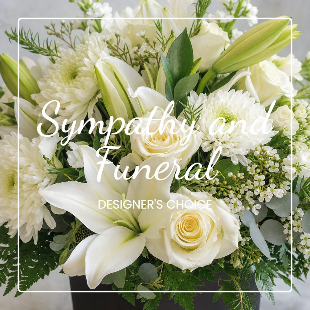 White sympathy arrangement with lilies, roses, and chrysanthemums