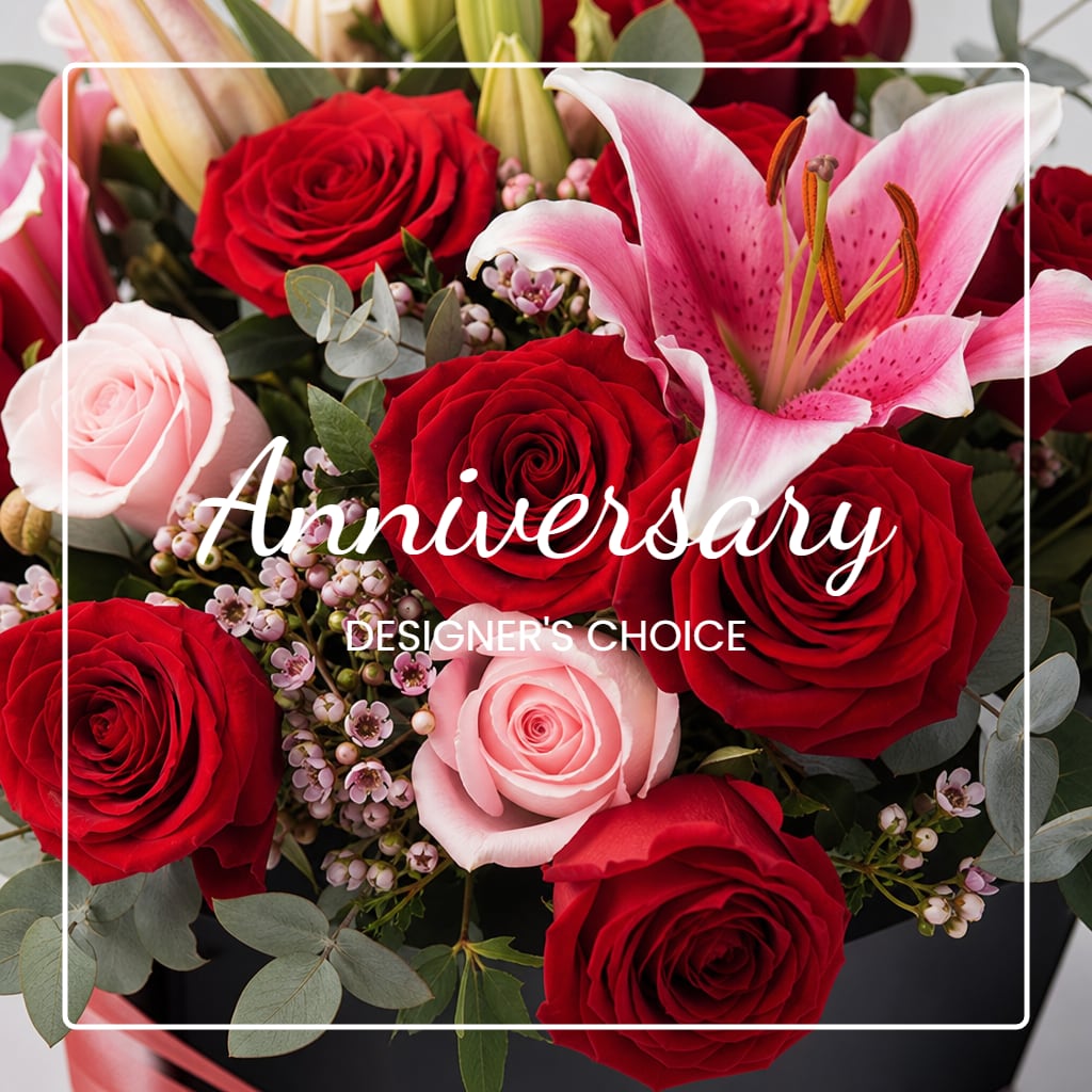 Red and pink roses with a pink lily in a black box