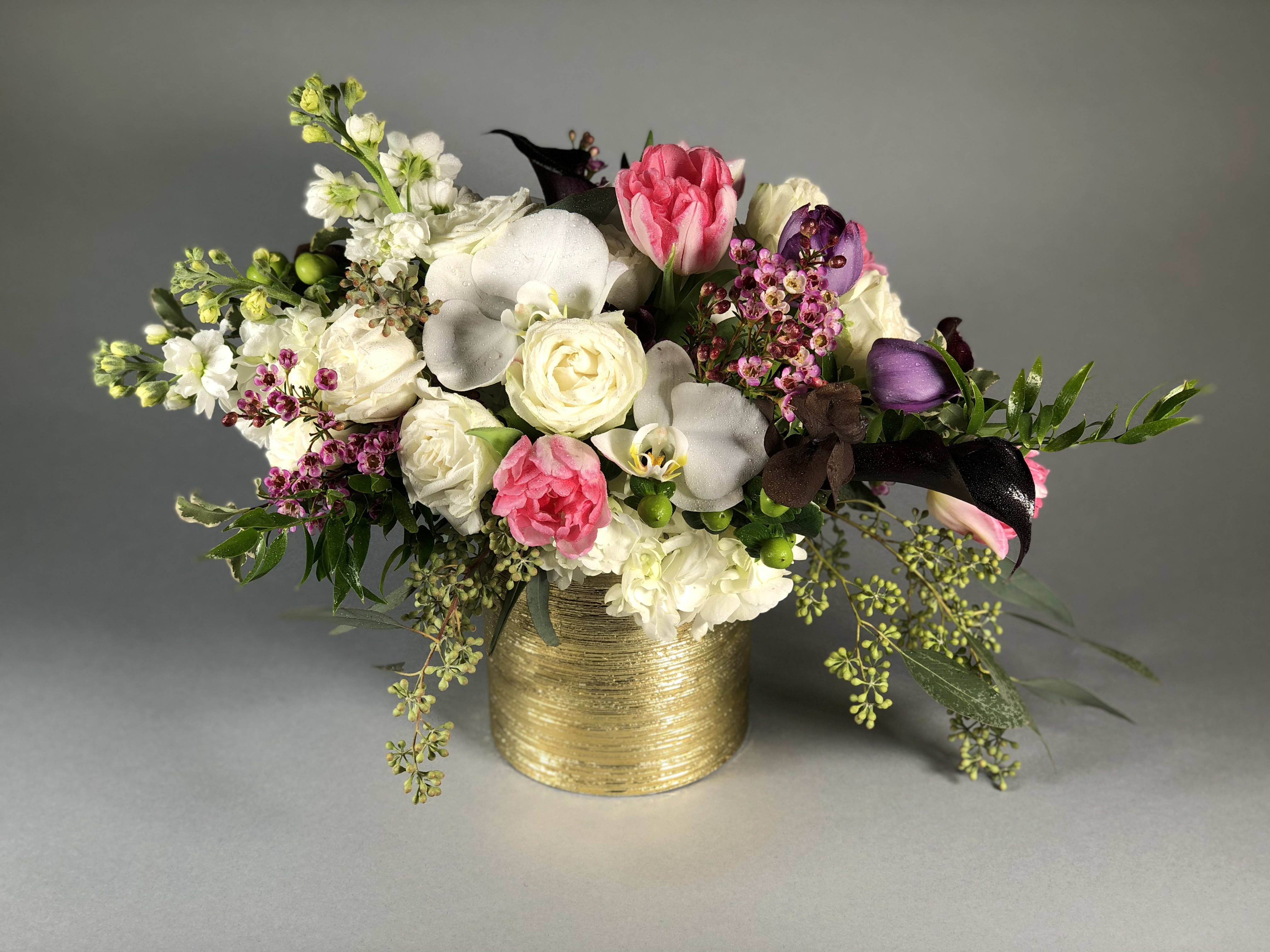 Bouquet of pink and white flowers in a gold vase