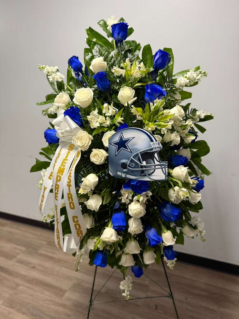 Standing floral wreath with blue and white roses and a football helmet tribute
