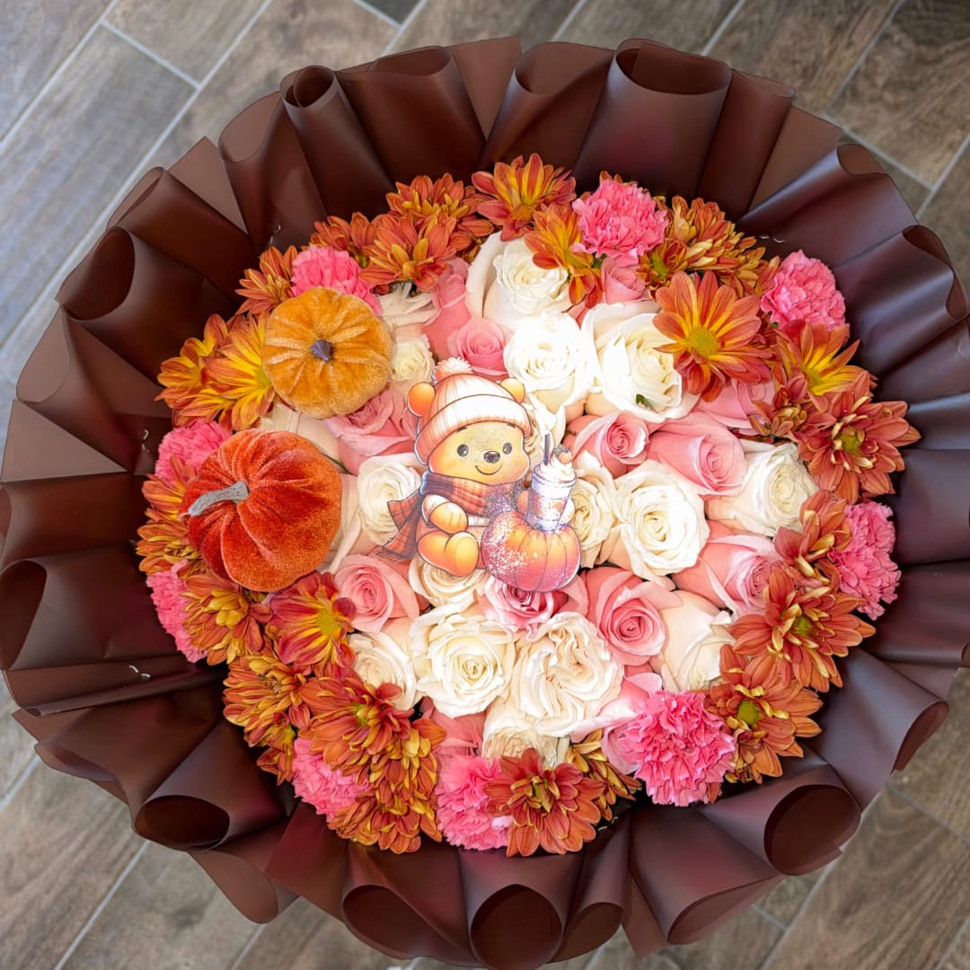 Bouquet of pink and white roses with orange chrysanthemums and plush pumpkins