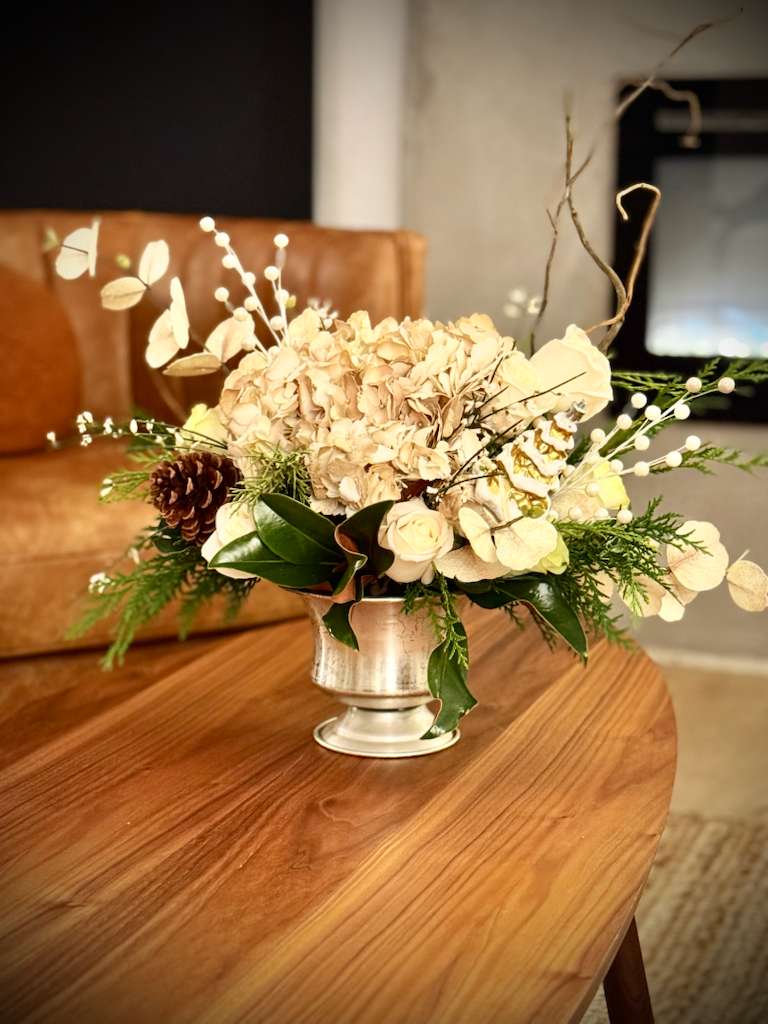 Neutral Winter Elegance Floral Arrangement - WEB  Our Neutral Winter Elegance Floral Arrangement is a refined seasonal design created with a soft, neutral color palette and natural winter elements.  Featuring seasonal florals, textured greenery, and organic accents, this arrangement brings warmth, calm, and timeless elegance to any space.  Perfect for living areas, dining tables, offices, hotels, or as a thoughtful seasonal gift.  Each arrangement is handcrafted with care and offered in limited quantities to ensure quality and exclusivity.   Seasonal flowers may vary based on availability while maintaining the overall design and neutral color palette.   