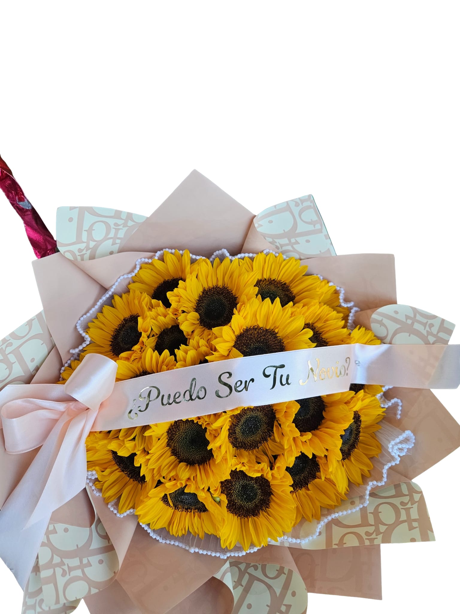Bouquet of yellow sunflowers wrapped in pink paper with a ribbon